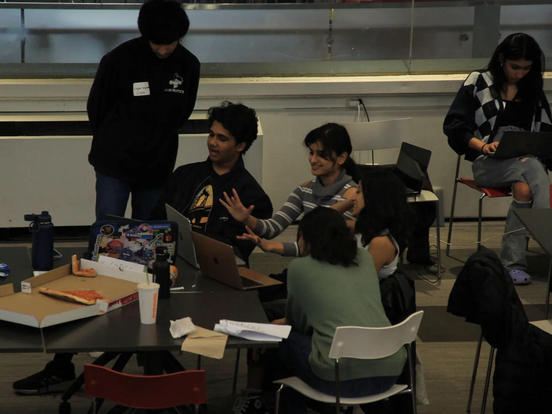 Students gathered around laptops during a build sprint