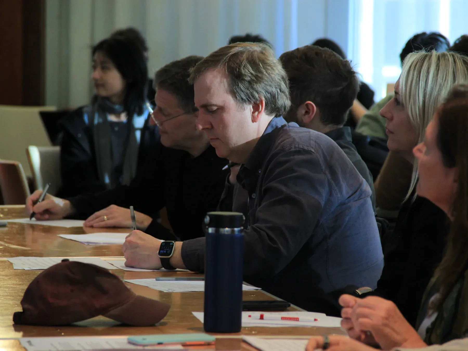 AINU students and judges reviewing project work together